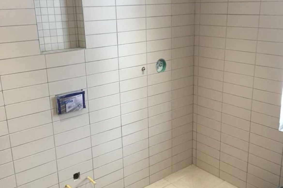 New tiles on wall in empty bathroom