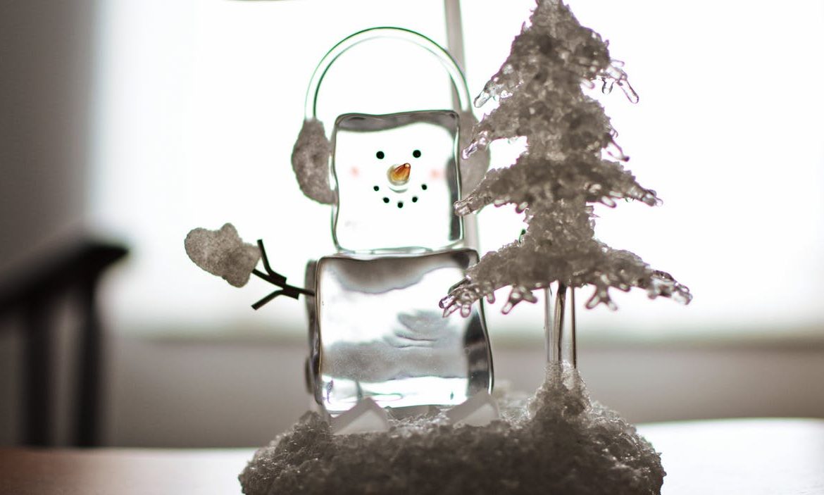 ice snowman next to an xmas tree
